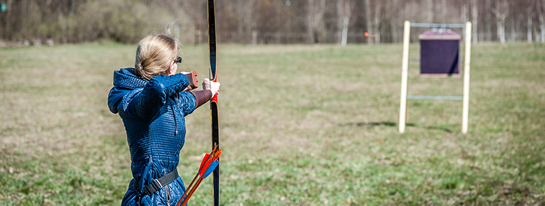 Individual shooting an arrow at a target