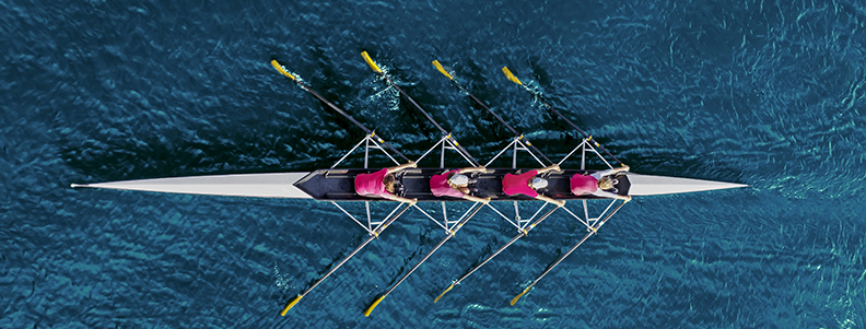 People rowing in a boat as a team
